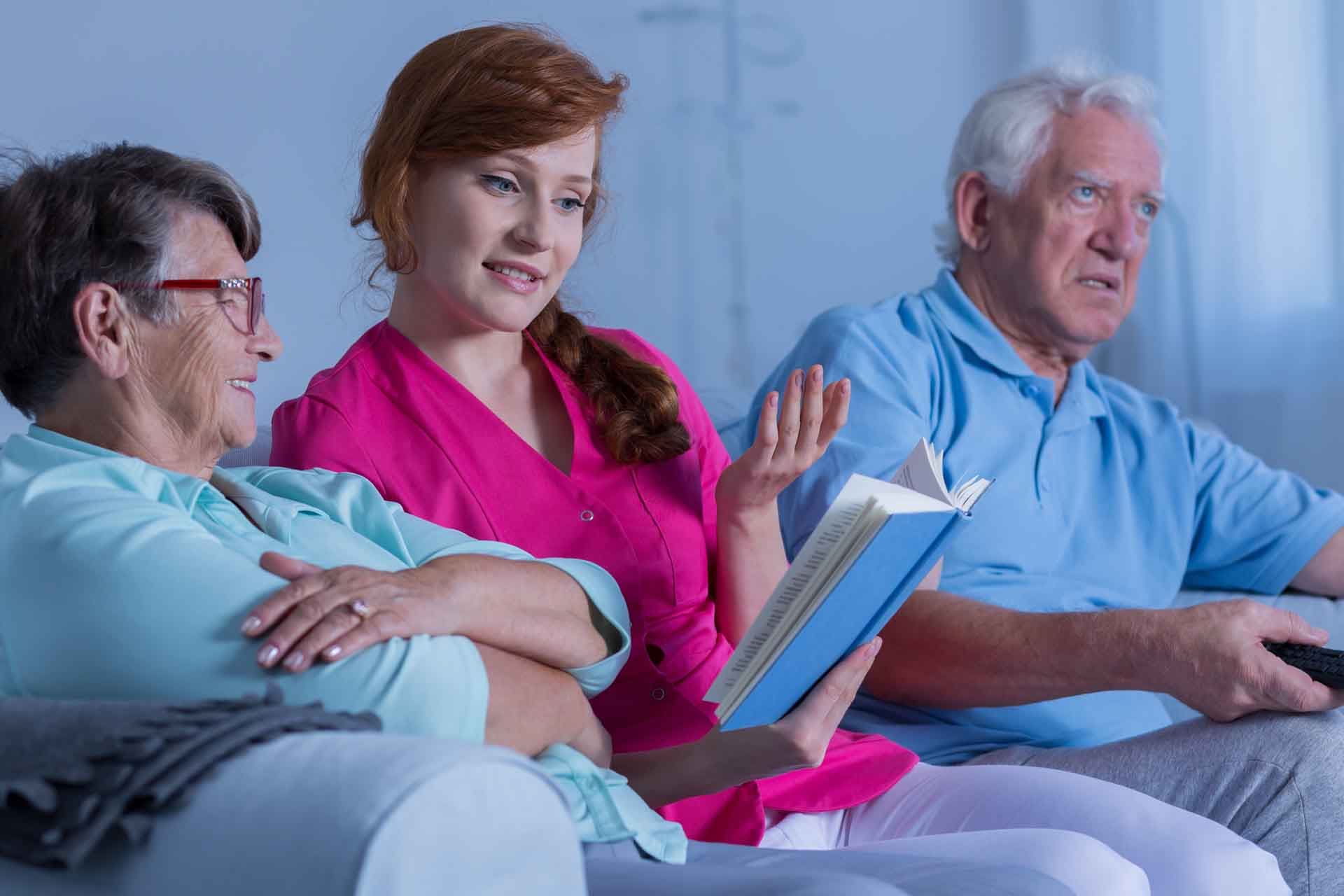 A caregiver spending time with residents at ADL Assisted Living