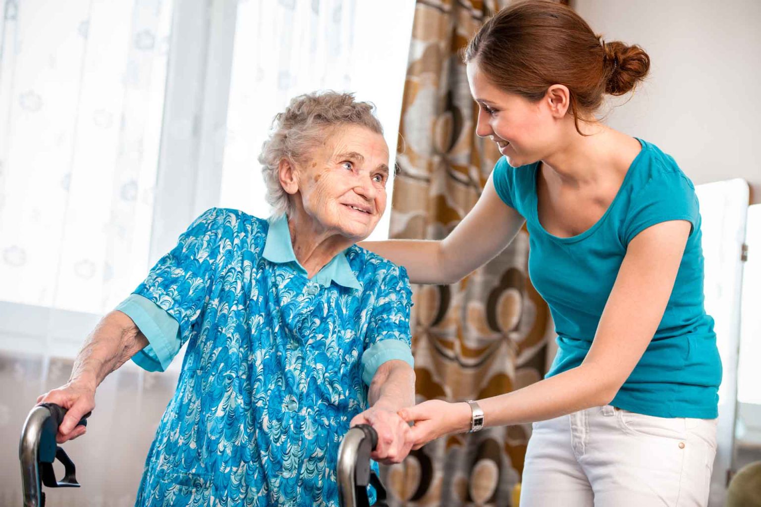 nurse assisting elderly woman